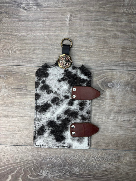 Trophy buckle display black and white hair on hide and gold, bronze, and silver concho.