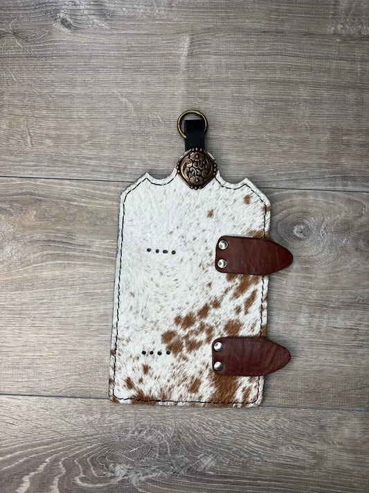 Trophy buckle display brown and white hair on hide with copper square concho