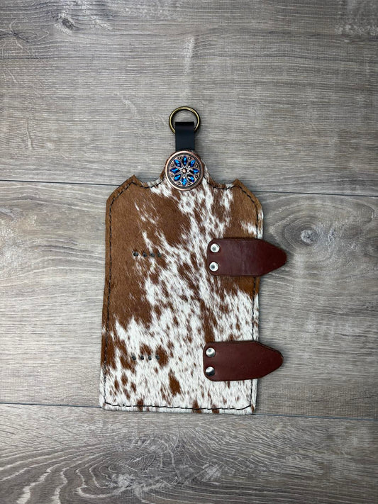 Trophy buckle display brown and white hair on hide and blue flower copper concho