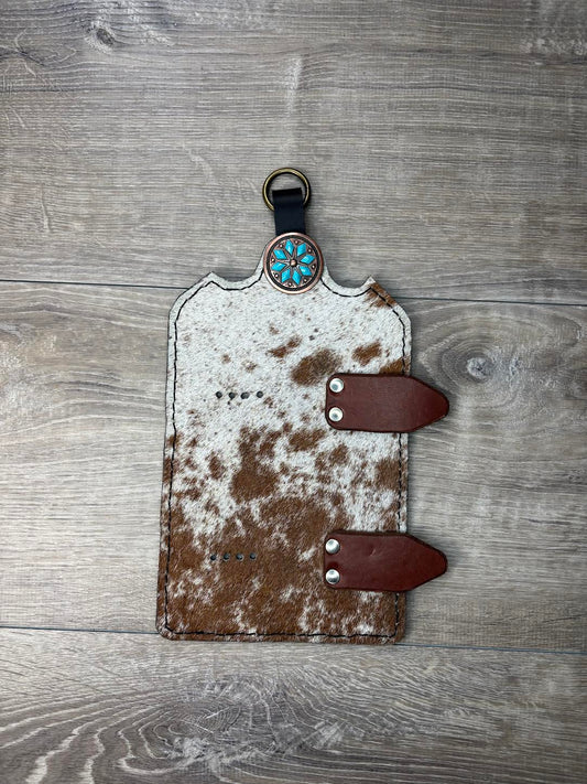 Trophy buckle display brown and white hair on hide and turquoise flower copper concho