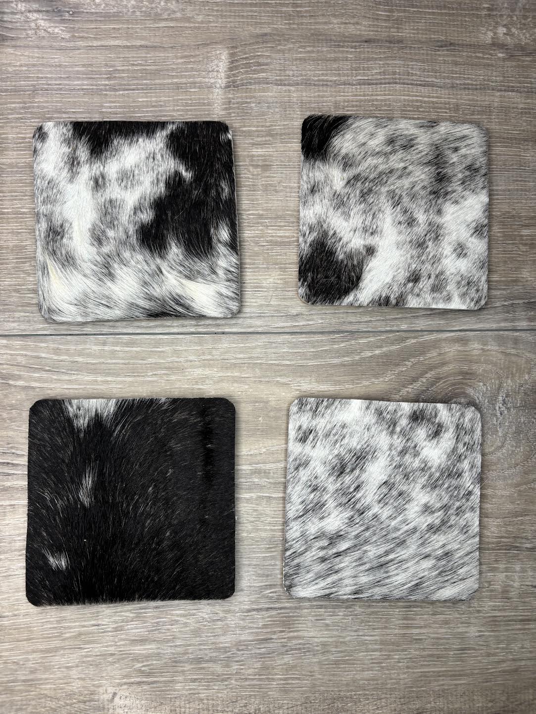 4 pack coasters - black/white hair on hide - patterns may vary