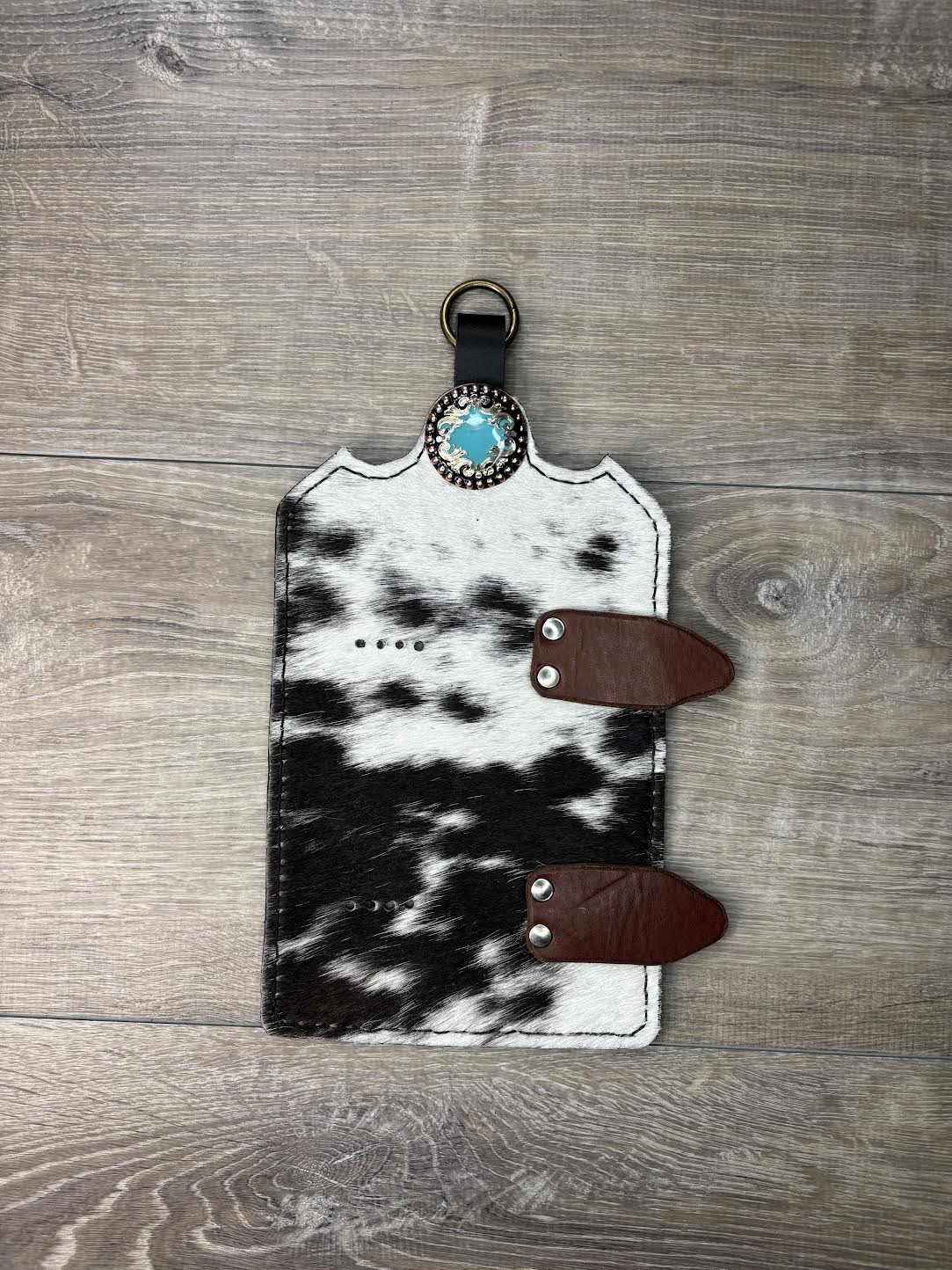 Trophy buckle display black and white hair on hide and turquoise, silver, and copper concho