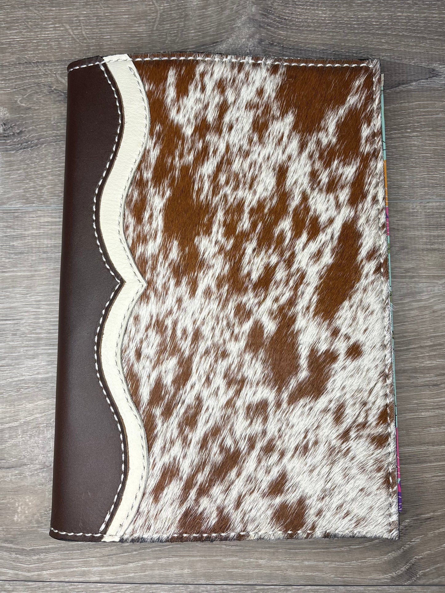 Brown and white cowhide planner