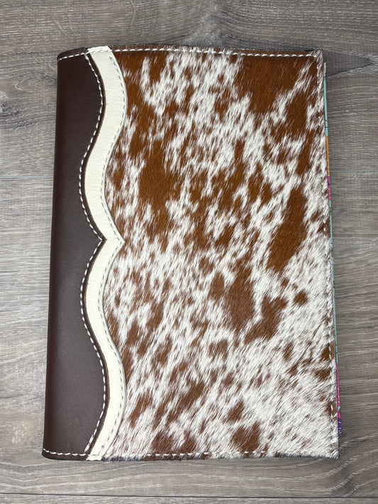 Brown and white cowhide planner